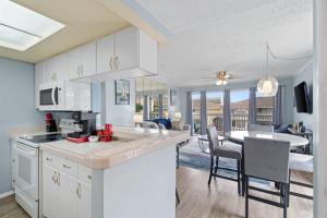 a kitchen and living room with a table and a dining room at Waterfront Summer Vacay Free Private Beach Chairs & Umbrella Sleeps 5 in Destin