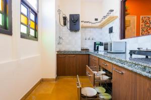 a kitchen with a counter with stools in it at Footprint Hostel Udaipur in Udaipur +43 photos