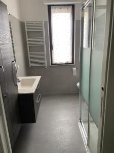 a bathroom with a sink and a toilet and a window at B&B Il Viale in Ponte dellʼOlio +17 photos