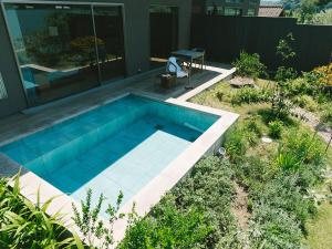 a swimming pool in the backyard of a house at HOTEL & KOTEI SOKA in Kyotango