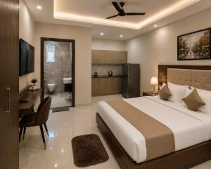 a bedroom with a bed and a desk and a bathroom at Sab proprty in Dānāpur