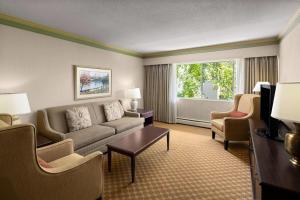 a living room with a couch and chairs and a window at Royal Scot Hotel & Suites, Trademark Collection by Wyndham in Victoria