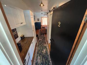 a black door with a number on it in a kitchen at Tin Town suites in Herberton