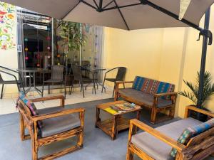 a patio with chairs and a table with an umbrella at Valicha Casa Hotel in Cusco