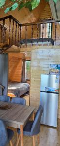 a dining room with a table and a refrigerator at Cottage Sunset 2 in Sakhalvasho +31 photos