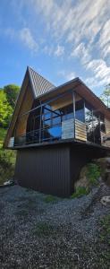 a house with a large window on the side of it at Cottage Sunset 2 in Sakhalvasho