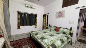 a bedroom with a bed and a window at Hardik villa in Udaipur