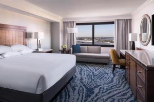 a hotel room with a large bed and a living room at Hyatt Regency Orlando in Orlando