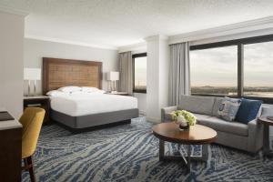 a hotel room with a bed and a couch at Hyatt Regency Orlando in Orlando +118 photos