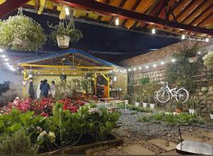 a garden center with flowers and a bike in the middle at TeeDalat House in Khu Chi Lăng