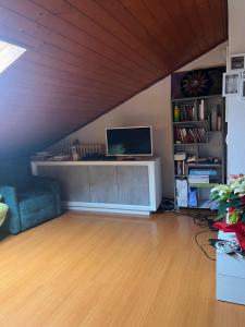 a living room with a desk with a computer on it at San Francisco in Borgo San Dalmazzo