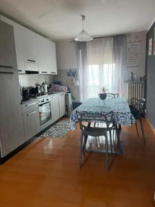 a kitchen with a table and a kitchen with a table and chairs at San Francisco in Borgo San Dalmazzo