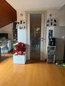 a living room with a door and a table with flowers at San Francisco in Borgo San Dalmazzo