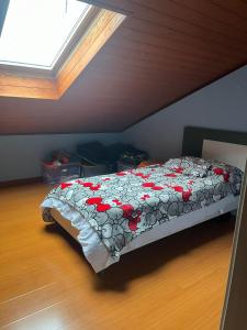 a bedroom with a bed with red flowers on it at San Francisco in Borgo San Dalmazzo