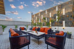 a patio with couches and tables on a building at Stay XO - A Luxurious 3BHK Villa in Panchkula in Panchkula