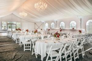 a banquet hall with white tables and chairs and chandeliers at Comfort Suites at Par 4 Resort in Waupaca +53 photos