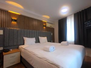 a bedroom with a large white bed with two pillows at Naila Hotel in Istanbul +173 photos
