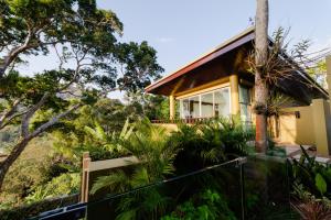 a house on a hill with a fence at Villa 18 Kata-Private Pool Villa with Sea View in Ban Kata
