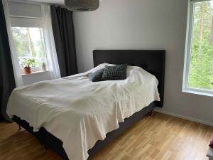 a bed with two pillows on it in a bedroom at Bergnäset in Luleå