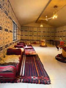 a room with a row of chairs and a rug at Wadi Rum Desert Secret in Wadi Rum