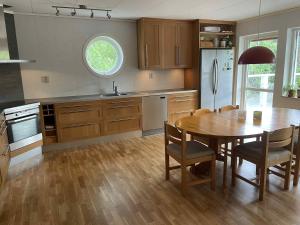 a kitchen with a wooden table and a dining room at Bergnäset in Luleå