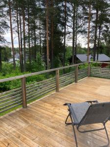 a chair sitting on the deck of a house at Bergnäset in Luleå