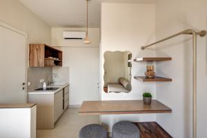 a kitchen with a table and a sink at Arxontissa Rooms in Ermoupoli