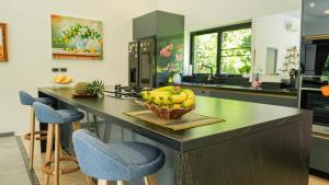 a kitchen with a counter with a bowl of bananas on it at Villa des Princes in Ban Thung