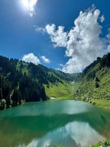 a large lake in the middle of a mountain at Karakol City Center in Karakol +21 photos