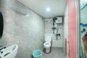 a small bathroom with a toilet and a sink at JM Guest House Lamaran RedPartner in Karawang +21 photos