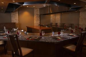 a restaurant with a long bar with wine glasses at Hilton Takayama Resort in Takayama