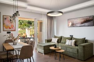 a living room with a couch and a table at Lumino Suites Corfu in Corfu +7 photos