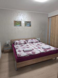 a bedroom with a bed with a quilt on it at Apartmán Kurdějov in Hustopeče +38 photos