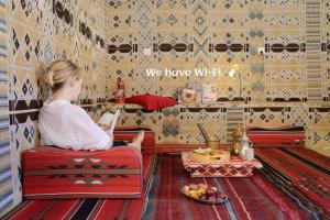 a little girl sitting in a chair in a room at Wadi Rum Desert Secret in Wadi Rum