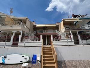 a house with a surfboard parked in front of it at Val beach apartment in Nea Potidaea