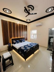 a bedroom with a bed and a ceiling fan at Hotel rahul prime in Gogameri
