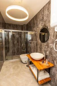 a bathroom with a sink and a shower at poseidon kınalıada in Kınalıada +62 photos