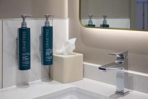 a bathroom with two toothbrushes on a sink at Hilton Edinburgh Carlton in Edinburgh +55 photos