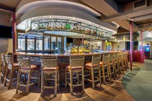 a bar in a restaurant with chairs and a counter at La Posada Lodge & Casitas, an Ascend Collection Hotel in Tucson