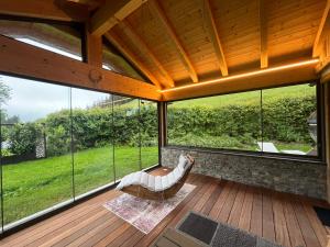 a room with large windows and a hammock on a deck at Ferienwohnungen Unterdürmoos Apartments mit Chalet-Charme auf 1050 m , Alleinlage in Annaberg im Lammertal +84 photos