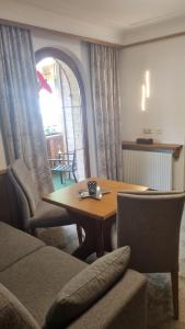 a living room with a wooden table and chairs at Adlerhorst , Gstan 31 in Finkenberg