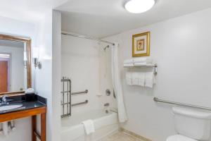 a bathroom with a shower and a toilet and a sink at Comfort Suites Longmont in Longmont