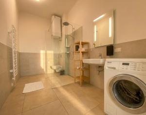 a bathroom with a washing machine and a sink at Villa Jahn in Baden