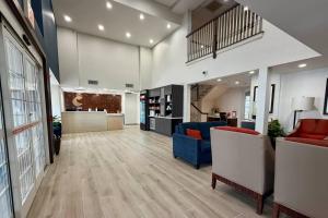 a lobby of a pharmacy with chairs and a counter at Comfort Inn & Suites Sturbridge-Brimfield in Sturbridge