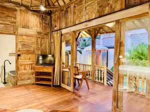 a living room with a television and a wooden wall at Sunshine dijoglo villa in Ubud