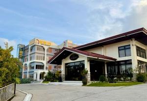 a building with a sign on the front of it at Achilles Hotel in Maitim +38 photos