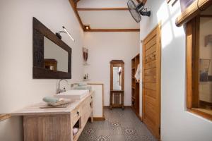 a bathroom with a sink and a mirror at Villa Casa Koko in Gili Islands