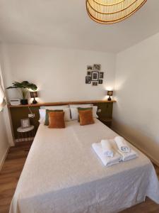 a bedroom with a large bed with two towels at Jaén Sky in Jaén