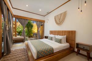 a bedroom with a king sized bed and a balcony at Villa Casa Koko in Gili Islands