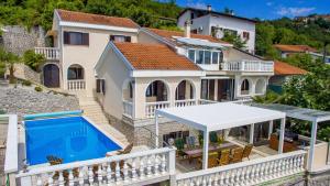 an image of a house with a swimming pool at Vila Iris - Opatija by Villas Guide in Breza